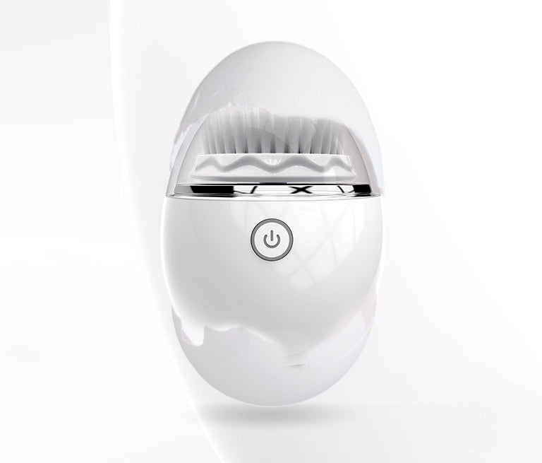White gold ultrasonic electric face washer with soft bristles and power button on white background