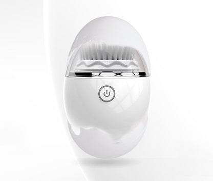 White gold ultrasonic electric face washer with soft bristles and power button on white background