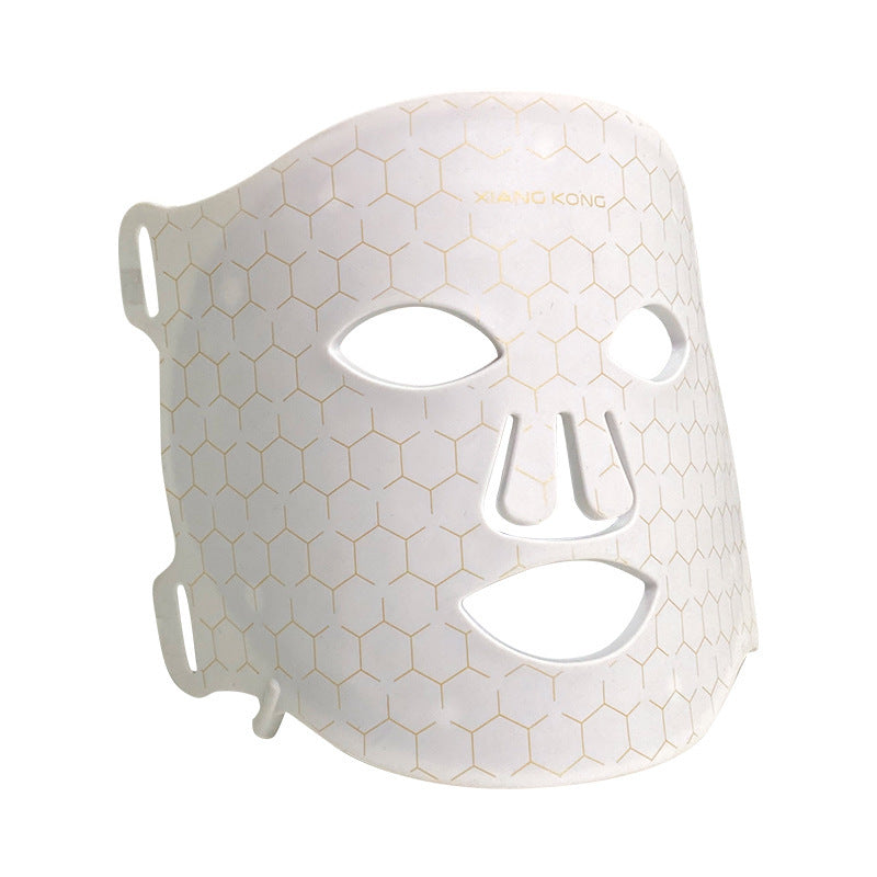 White IPL skin rejuvenation LED mask with hexagonal pattern and eye, nose, mouth cutouts