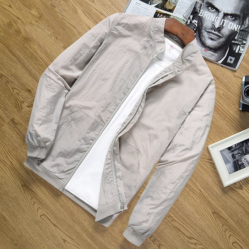 Light beige men's lightweight sun protection jacket with zipper on wooden surface