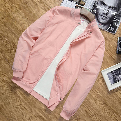 Lightweight pink men's sun protection jacket with zip and ribbed cuffs on wooden surface