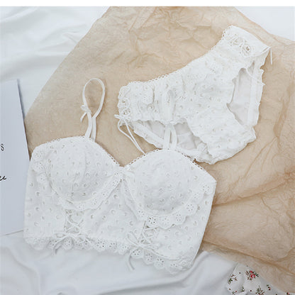 White lace cotton bra and matching high-waist panties lingerie set on beige and white fabric