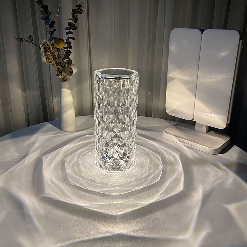 White USB crystal table lamp with acrylic shade creating soft glowing light and reflections on white surface