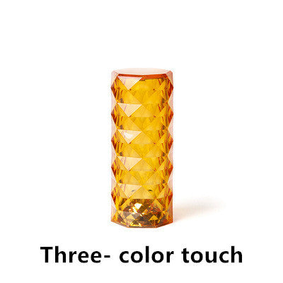 Amber crystal table lamp with geometric pattern, touch dimming, and USB port on white background