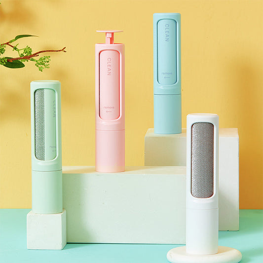 Set of reusable pet hair remover brushes in pastel colors on white blocks against yellow background