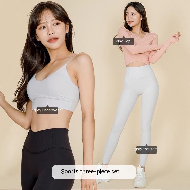 Two women modeling trendy three-piece stretch activewear sets for fitness and workout sessions