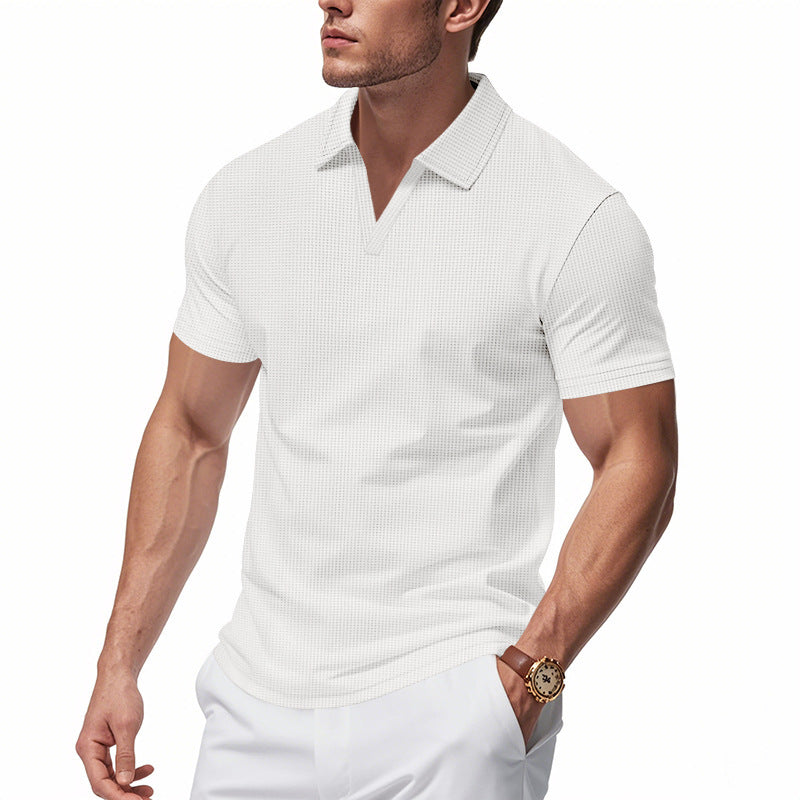 Male model wearing white slim fit men's waffle polo v-neck shirt with short sleeves and collar