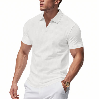Male model wearing white slim fit men's waffle polo v-neck shirt with short sleeves and collar