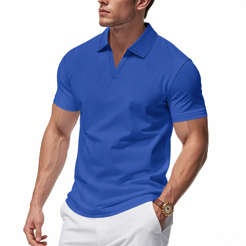 Man wearing blue slim fit waffle knit polo shirt with V-neck and white pants