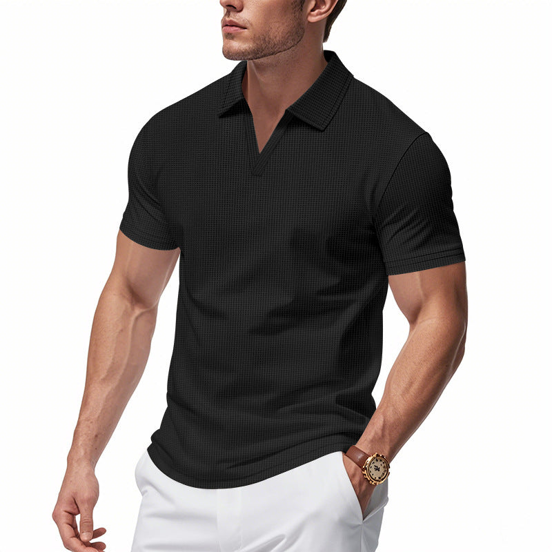 Fit man wearing black waffle polo slim fit V-neck shirt paired with white pants and brown watch
