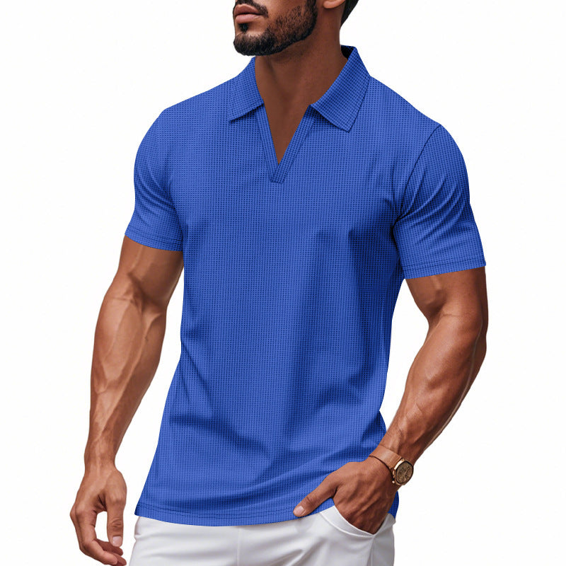 Muscular man wearing blue waffle polo shirt with V-neck and white pants, casual summer style