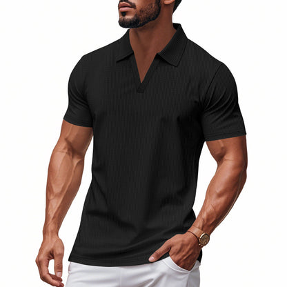 Muscular man wearing black slim-fit waffle knit V-neck polo shirt and white pants