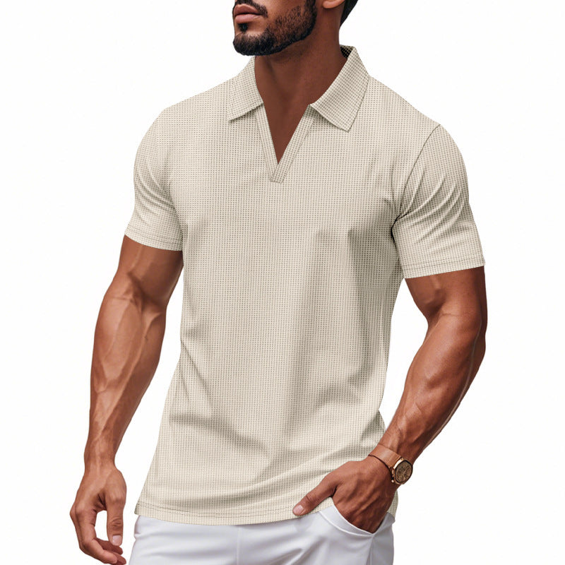 Muscular man wearing a light beige waffle polo slim fit V-neck shirt with short sleeves