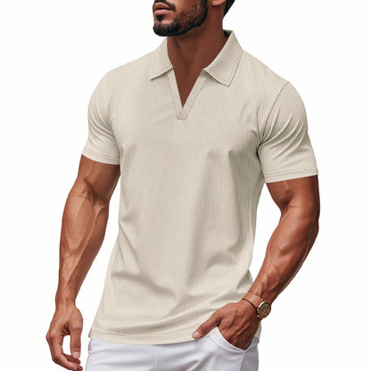 Muscular man wearing a light beige waffle polo slim fit V-neck shirt with short sleeves