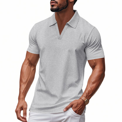 Muscular man wearing white men's waffle polo slim fit V-neck shirt with short sleeves