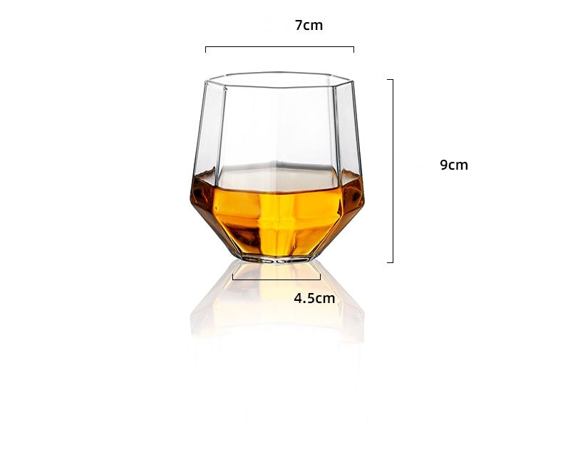 Clear faceted whiskey glass with amber liquid, measuring 7cm width, 9cm height, and 4.5cm base