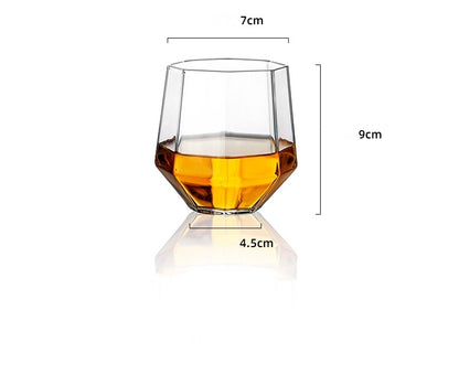 Clear faceted whiskey glass with amber liquid, measuring 7cm width, 9cm height, and 4.5cm base