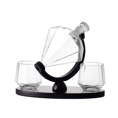 Diamond-shaped whiskey decanter and two matching glasses on black stand barware set