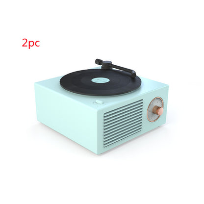 Retro mini phonograph record player in pastel blue with black vinyl, gold tone dial, and speaker grille