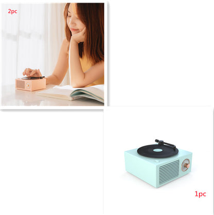 Retro mini phonograph Bluetooth speaker in pastel blue with vinyl record on top, portable wireless audio device