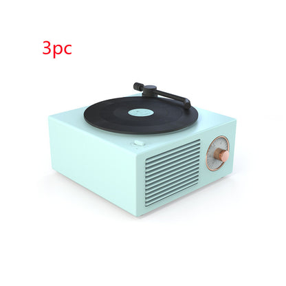 Retro mini phonograph Bluetooth speaker in pastel blue with black vinyl record and copper dial