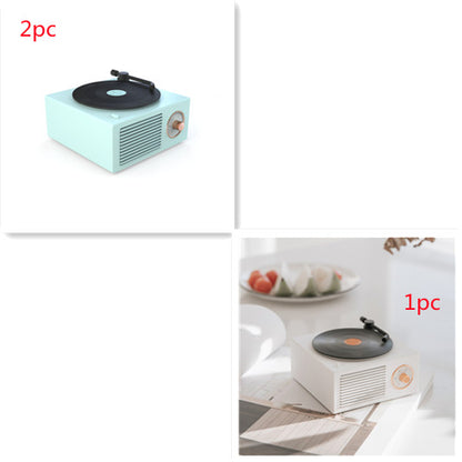 Compact retro mini phonograph Bluetooth speaker in pastel blue and white on white background