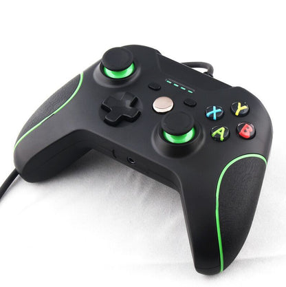 Black wired USB game controller with green accents, dual analog sticks, D-pad, and colored ABXY buttons