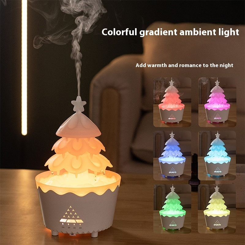 White Christmas tree shaped aroma diffuser with colorful gradient ambient light and remote control on wooden table