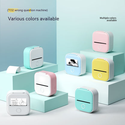 Compact portable mini thermal printers in pastel colors on blue display blocks, printing photos and text