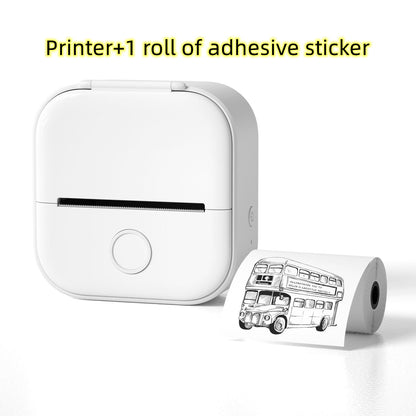 White portable mini thermal printer with a roll of adhesive sticker showing a black and white double-decker bus print