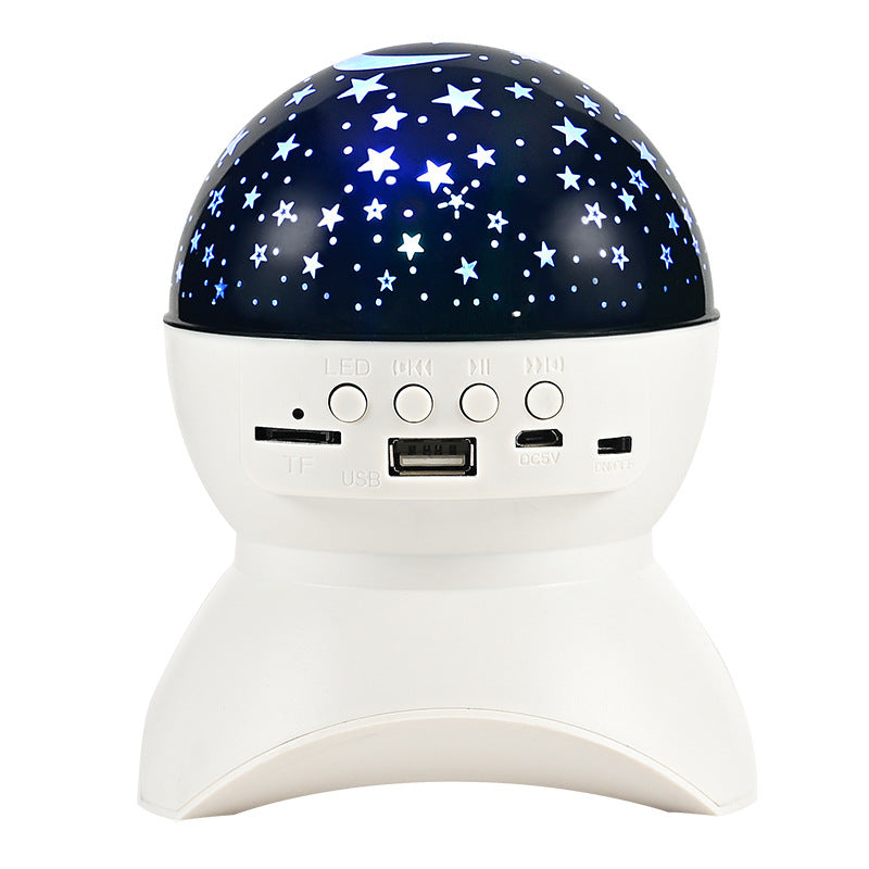 White Bluetooth speaker with star projector night light featuring buttons and USB, TF card slots