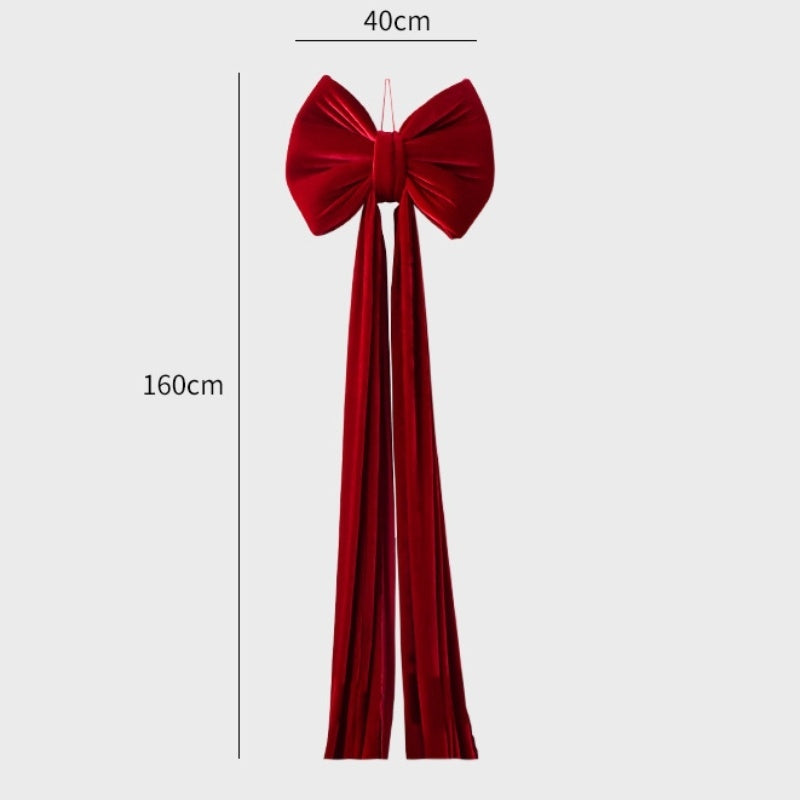 Large red velvet Christmas bow decoration with long tails, measuring 40cm by 160cm