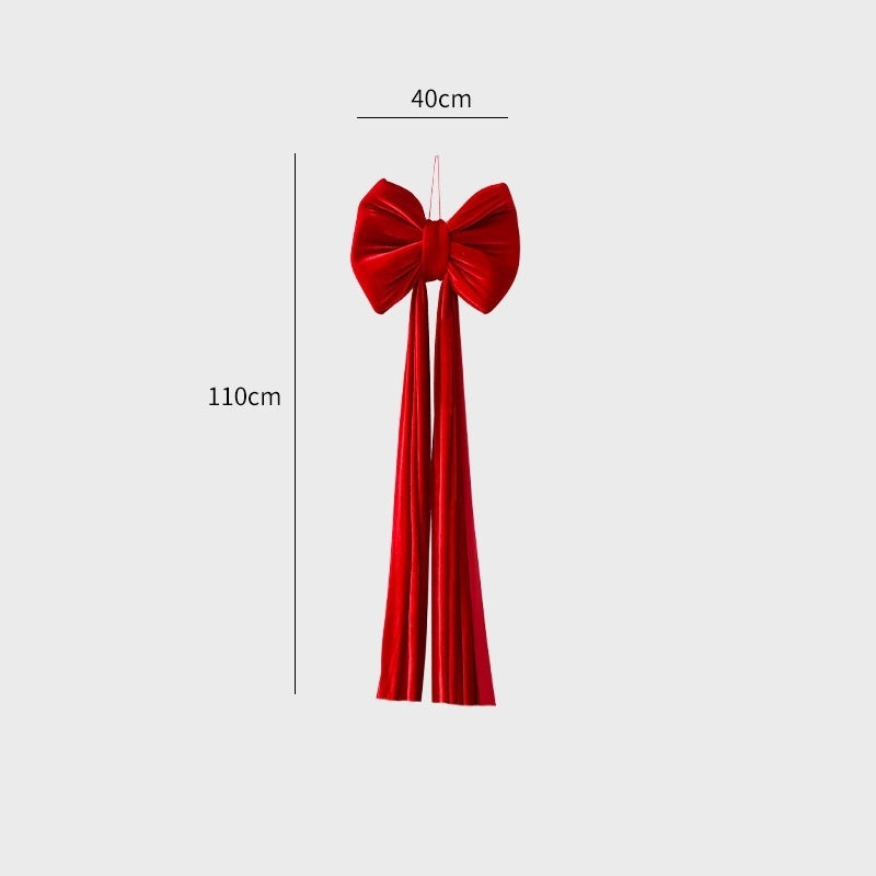 Red velvet large Christmas bow decoration with long tails, measuring 40cm wide and 110cm long