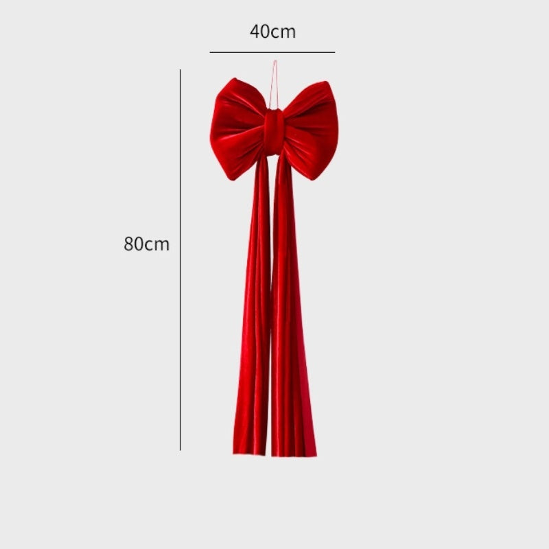 Large red velvet Christmas bow decoration with long tails, measuring 40cm by 80cm