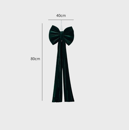 Large green velvet Christmas bow decoration with long tails, measuring 40cm wide and 80cm long