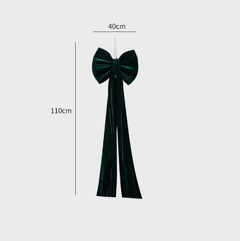 Dark green velvet large decorative bow with long tails, measuring 40cm wide and 110cm long