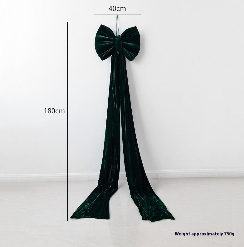 Large dark green velvet bow decoration with long trailing ribbons, measuring 40cm wide and 180cm long