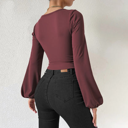 Back view of woman wearing trendoligy burgundy lantern sleeve slim fit base shirt and black jeans