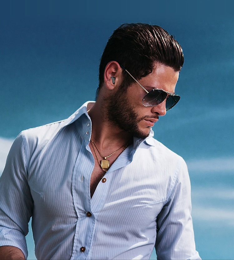 Man wearing black Trendoligy XG8 noise reduction sports headphones and sunglasses against blue sky