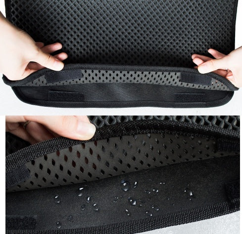 Hands holding a black waterproof EVA honeycomb cat litter mat with water droplets on the inner layer