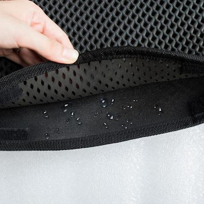 Close-up of black waterproof EVA cat litter mat with honeycomb design and water droplets inside