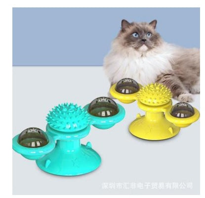 Fluffy cat with blue eyes near yellow and blue interactive rotating windmill catnip toys with suction cups