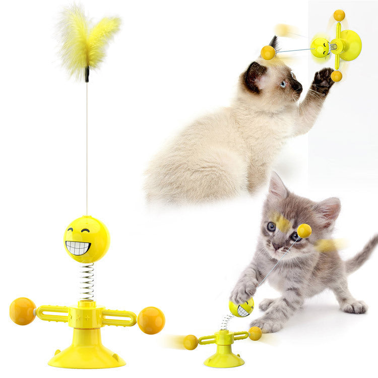 Yellow interactive catnip toy with smiling face, feathers, and suction cup, kittens playing