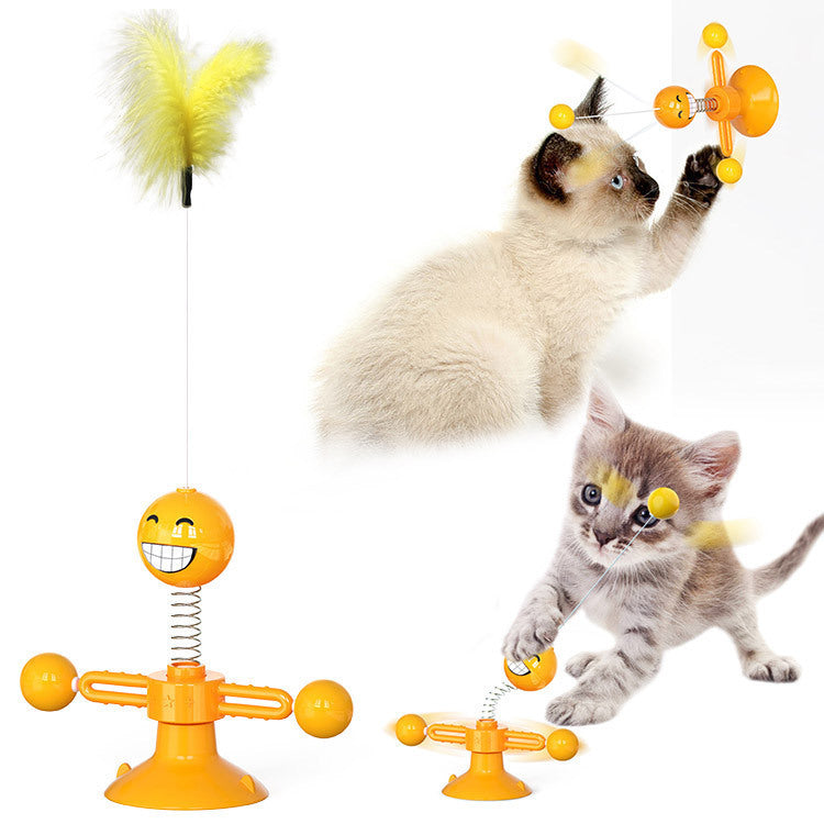Interactive yellow catnip windmill toy with suction cup and spinning balls, played with by two kittens