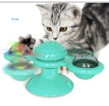 Gray tabby cat playing with yellow rotating windmill catnip suction cup toy for interactive play