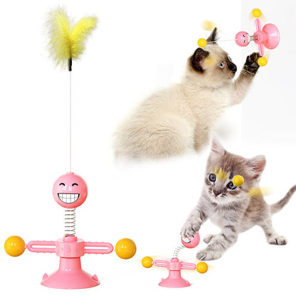 Pink interactive cat toy with yellow feather and suction cup, played with by kittens