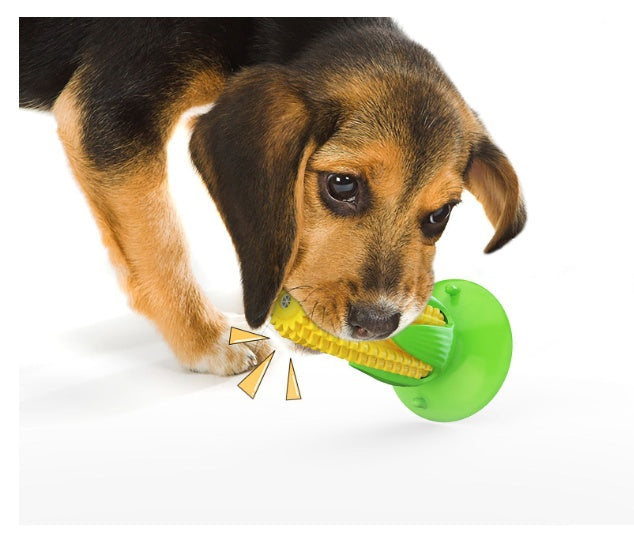 Puppy chewing a yellow corn dog chew toy with green base, durable interactive TPR dog dental toy with squeaker
