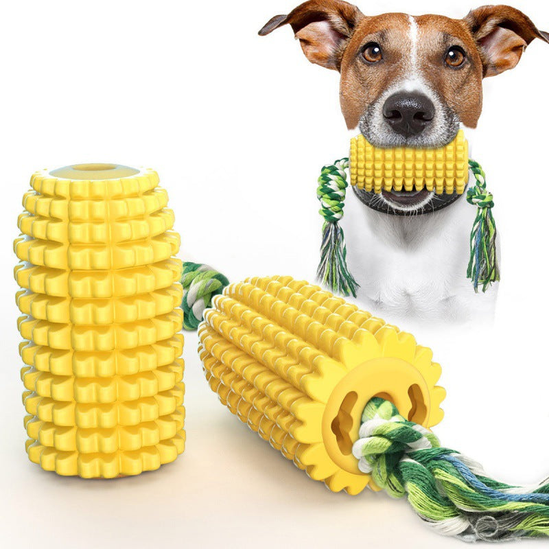 Dog chewing a yellow corn-shaped durable interactive TPR dog toy with green rope and squeaker