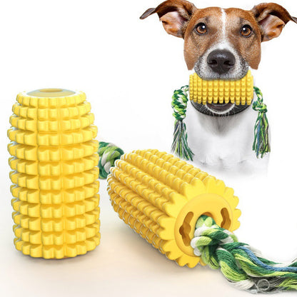 Dog chewing a yellow corn-shaped durable interactive TPR dog toy with green rope and squeaker