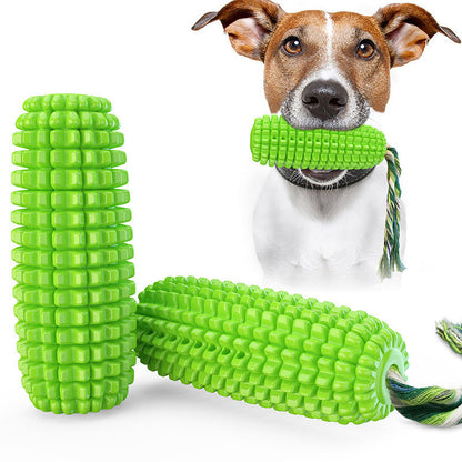 Green corn-shaped durable dog chew toy with rope, held by a dog with brown and white fur